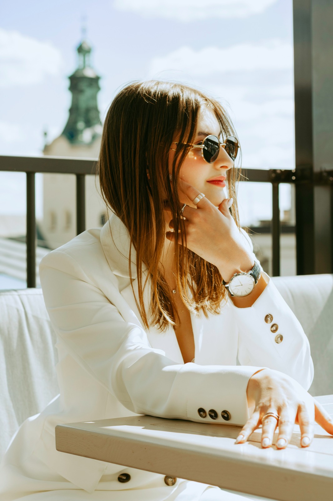 A woman in a white suit on a rooftop in Lviv